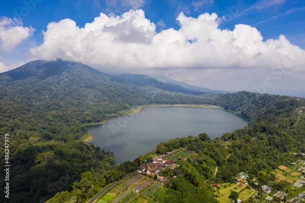 Fototapeta Aerial view of the lake Tamblingan in the Bali Highlands in Indonesia on a sunny day in Southeast Asia
