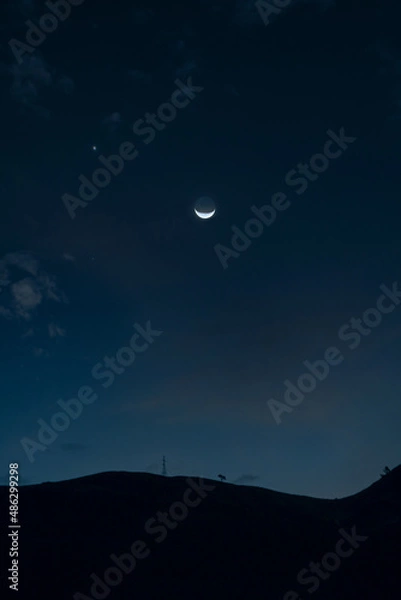 Fototapeta luna creciente y silueta de una montaña para fondos y diseños ..... crescent moon and silhouette of a mountain for backgrounds and designs
