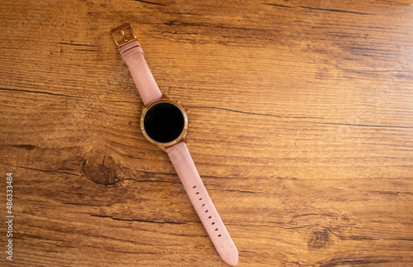 Obraz Smartwatch isolated on wooden background