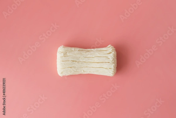 Fototapeta Dried cracked soap on a pink background. Empty space for the text.