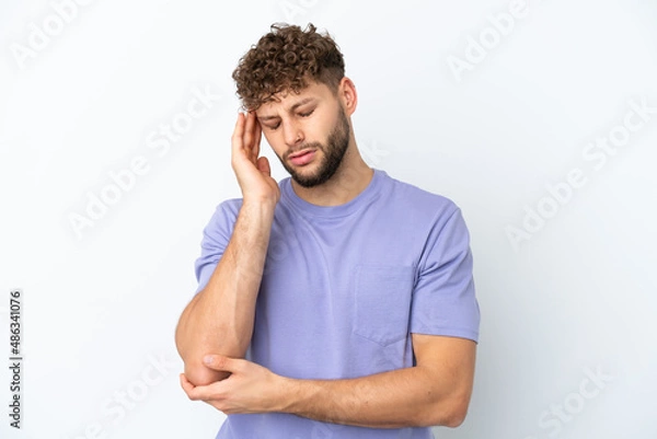 Fototapeta Young handsome caucasian man isolated on white background with headache