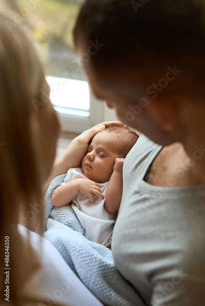 Fototapeta portrait of Unrecognizable parents holding their newborn baby