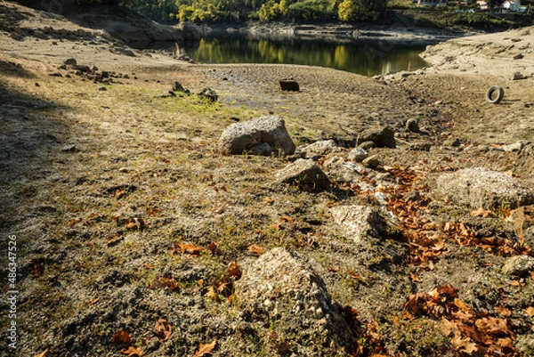 Fototapeta Very low water reservoir level in Ermal, north of Portugal due to drought in this time of the year - February 2022. Normally this part of the reservoir is usually full of water