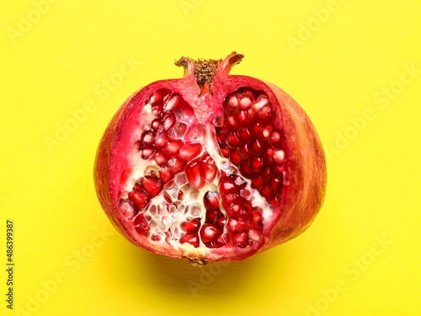Obraz Ripe delicious pomegranate on yellow background