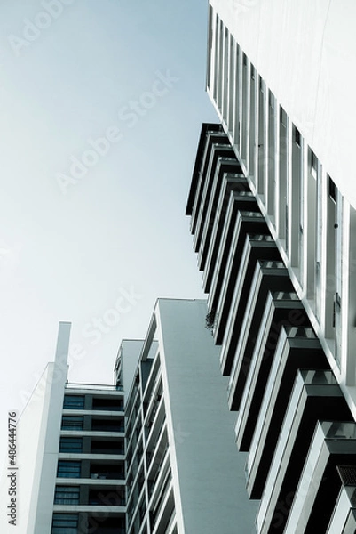Fototapeta Blue monochrome image of modern multistory residential buildings