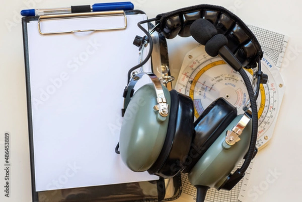 Fototapeta Flight headset, navigation computer and pilot kneeboard as a concept for flight training