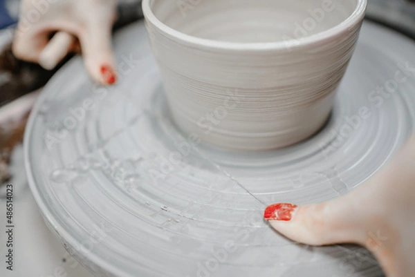 Obraz Modeling clay on a potter's wheel