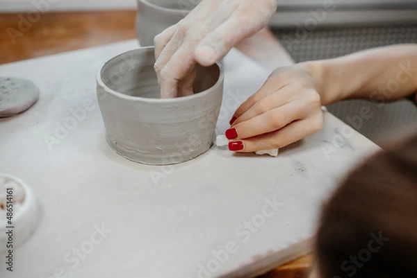 Obraz Modeling clay on a potter's wheel