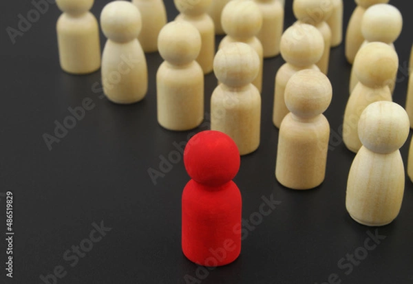 Fototapeta Leader and management concepts, Wooden figure stand in rows and red leader.