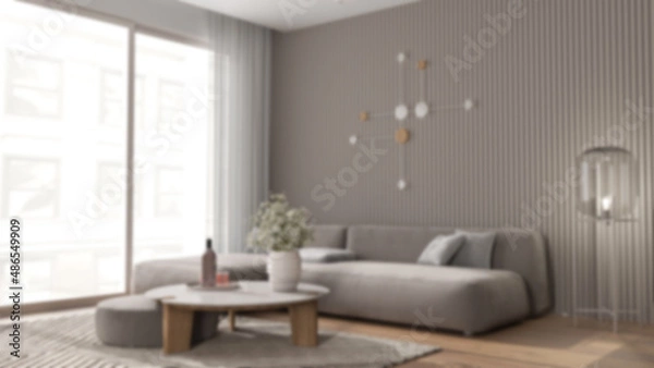 Fototapeta Blur background, living room in modern apartment, velvet sofa with pouf and table with potted flowers, parquet, carpet, big window, and floor glass lamp. Interior design idea