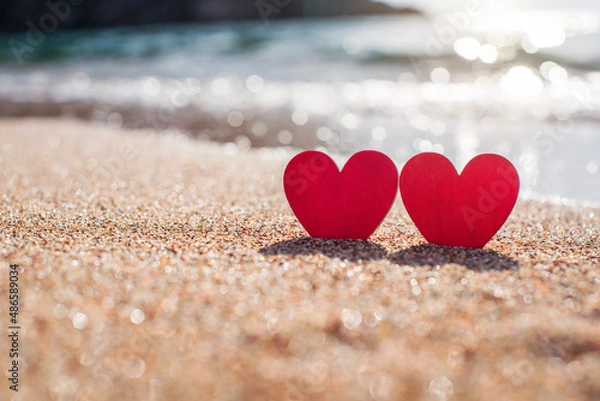 Fototapeta romantic symbol of two hearts on the beach
