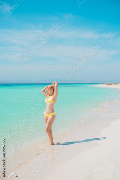 Fototapeta  Beautiful plus size young woman on a sand rest at nature at sea, concept of woman's life. Lady L-XL size having fun on a beach