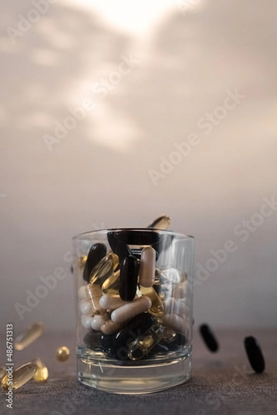 Fototapeta Vitamins and dietary supplements close-up. Macrophoto of capsules. Vitamins on the table.