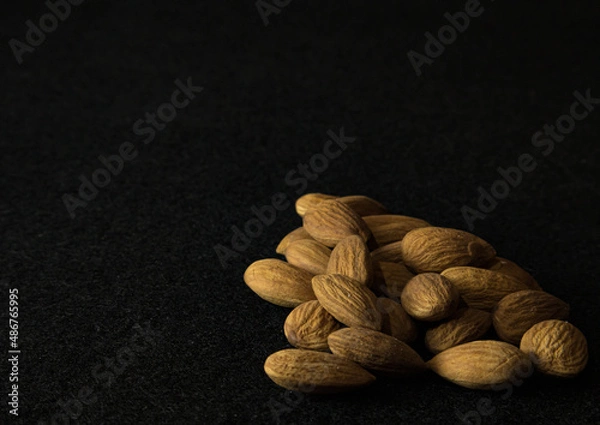 Fototapeta almonds on black background 