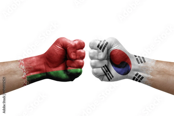 Fototapeta Two hands punch to each others on white background. Country flags painted fists, conflict crisis concept between belarus and south korea