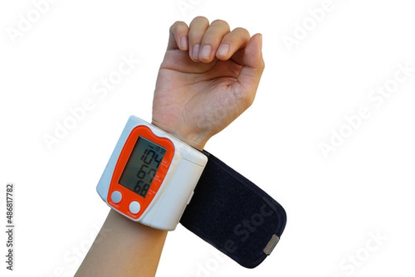 Fototapeta A compact and easy-to-carry wrist-type sphygmomanometer. Blood Pressure Monitors on human small wrist of thin people on isolated white background. convenient for storage and carrying. Medical device.
