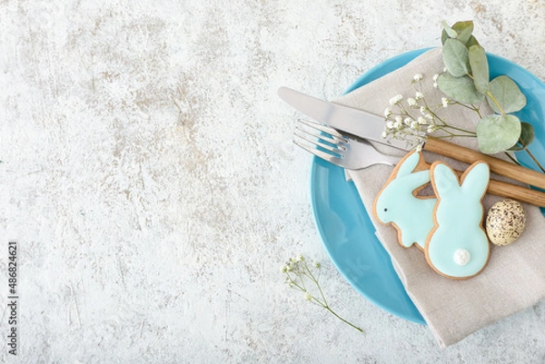 Fototapeta Easter table setting with cookies in shape of bunny on light background, closeup