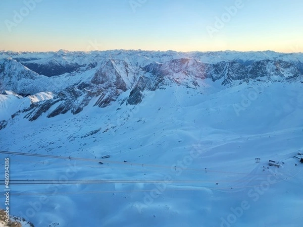 Fototapeta Panorama of ski resort in the german alps. Skiers on a slope on a sunny winter day.