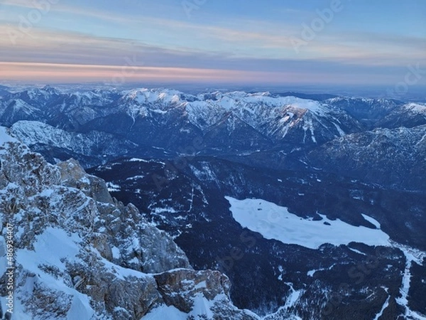 Fototapeta Aerial view on a frozen mountain lake in the alps. View from the top of germany.