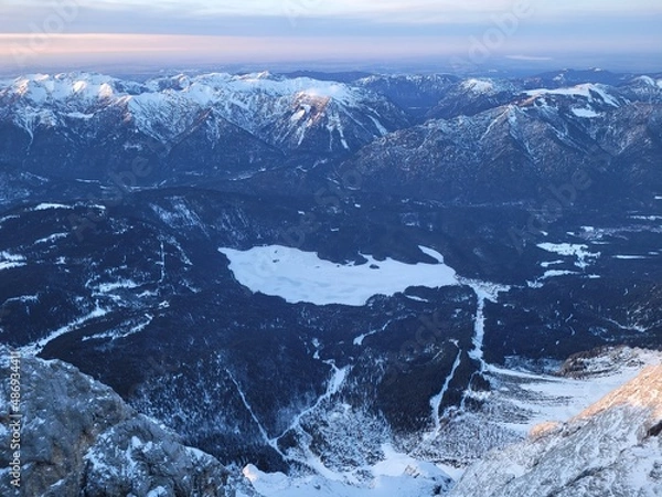 Fototapeta Aerial view on a frozen mountain lake in the alps. View from the top of germany.