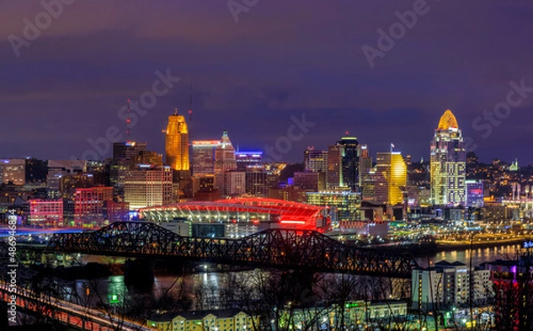 Fototapeta Cincinnati, Ohio USA - February 12, 2022: Panoramic View of the Cincinnati Skyline Lit Up in Orange in Honor of the Cincinnati Bengals NFL team having made it to the Superbowl
