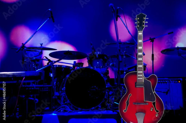 Fototapeta Electric guitar on the background of the stage with musical instruments.