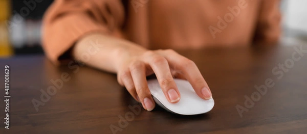 Fototapeta Close up of hand press the button computer mouse on table.