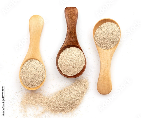 Fototapeta Dry yeast in wooden scoop isolated on white background