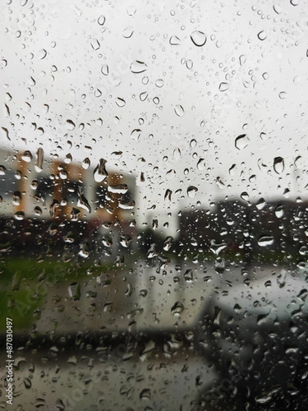 Fototapeta car mirror through glass with drops in the dark