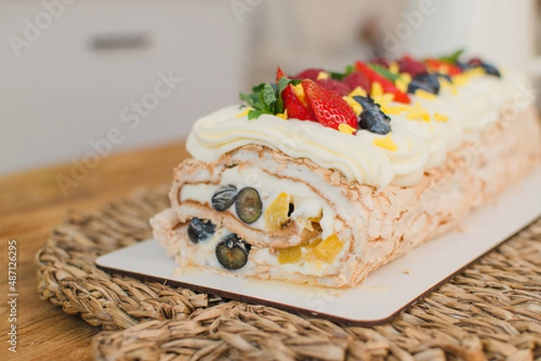 Fototapeta berry roll decorated with raspberry strawberries and blackberries in a section. Close-up