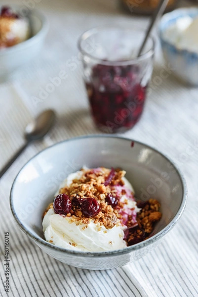 Fototapeta Cherry sauce, cream cheese and feta cream and crumble crust dessert. Homemade Sweet and salty cheesecake. Trifle. Selective focus