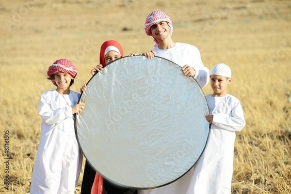 Obraz Arabic family in nature holding copy space banner
