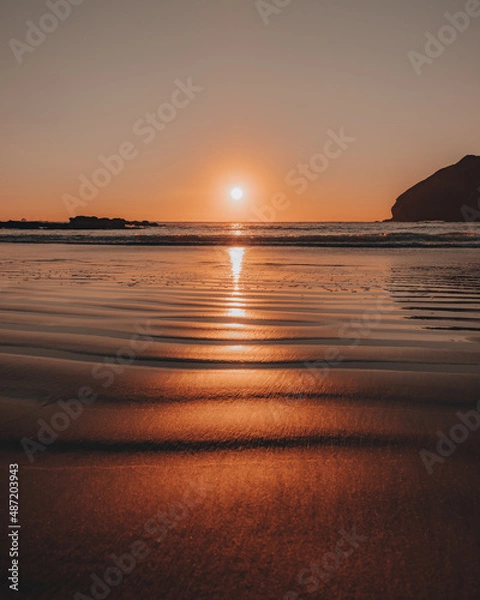 Obraz Sunset reflection on the warm beach sand by the ocean