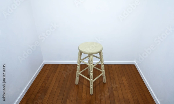 Fototapeta White room with a white round stool in the middle.