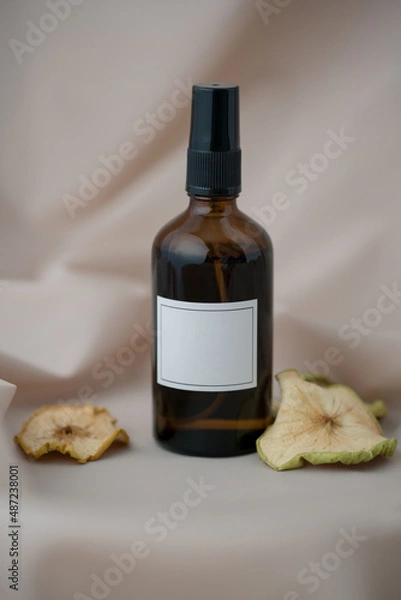 Obraz A bottle for essential oils, perfumes with a decoration of dried apples