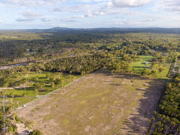 Fototapeta field surround by forrest