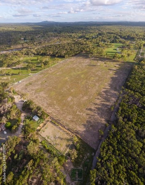 Fototapeta field surround by forrest