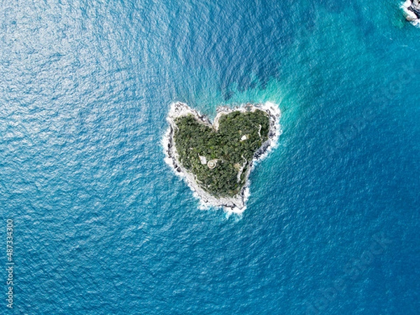 Fototapeta Aerial view of Bergeggi island, heart island from above, in Liguria, north Italy. Drone photography of the Ligurian coast, province of Savona with Spotorno and the island of Bergeggi.