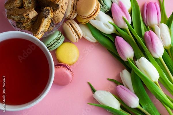 Obraz flat lay with tulips, tea and sweets on pink background