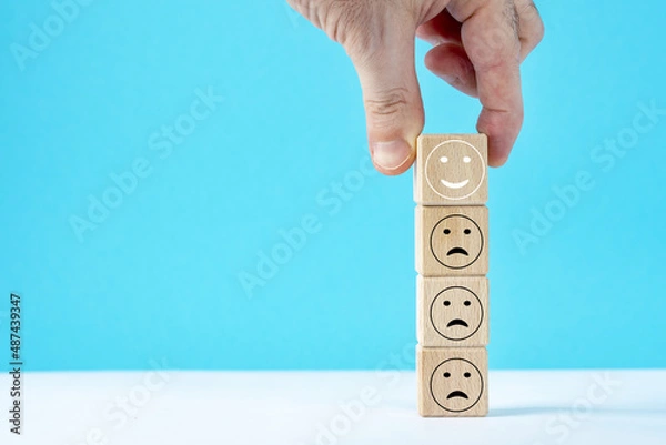 Fototapeta hand keep wooden cube with symbol positive face.