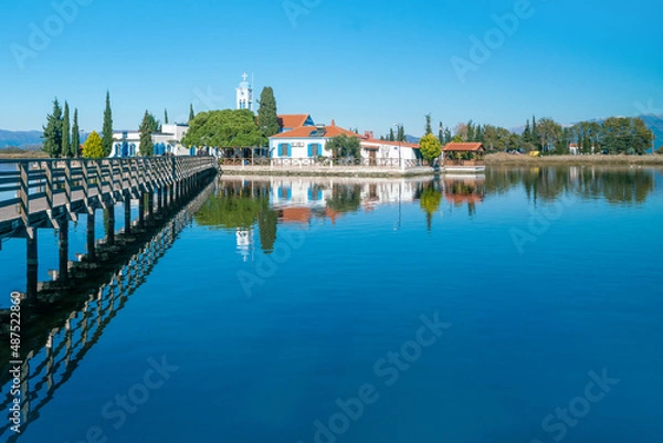 Fototapeta Nicholas, built on lake vistonida, port of lagos, xanthi region in northern greece. Magnificent landscape of a european country. View from the bridge to the beautiful monastery of st. Architecture