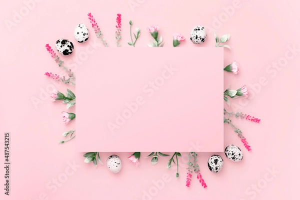 Fototapeta Easter composition. Easter eggs, flowers, paper blank on pastel pink background. Flat lay, top view, copy space.