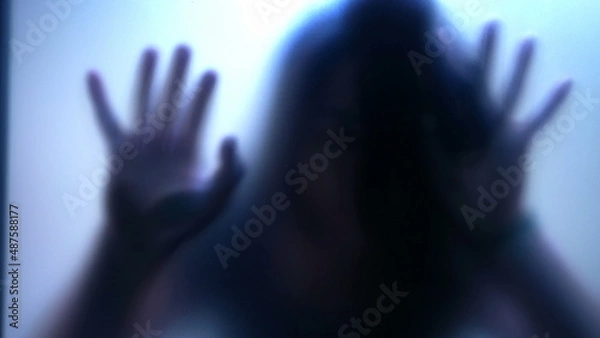 Fototapeta Defocused shot of person trapped in emotional problems behind glass depression concept