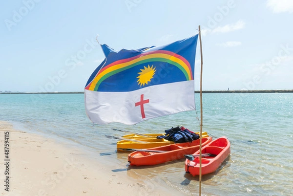 Fototapeta Pernambuco state flag waving with the wind at Muro Alto beach, a famous beach of Porto de Galinhas, Ipojuca city, Brazil. Beach tourist destination on the northeast coast.