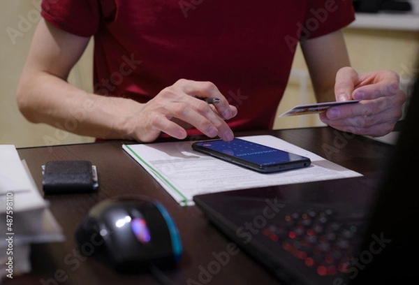 Obraz young man doing his taxes