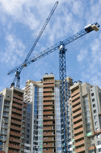 Obraz Blue construction cranes against the spring blue sky.