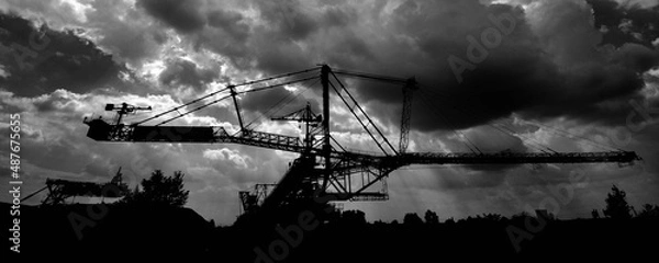 Obraz Giant bucket wheel excavator on stromy cloudy day sunbeams