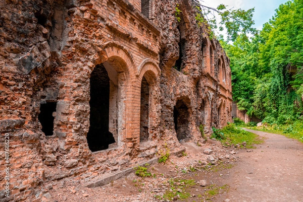 Obraz Walking path through ruins of old fortification fort on sunny day, Remains of ancient old fort with crumbling bricks wall