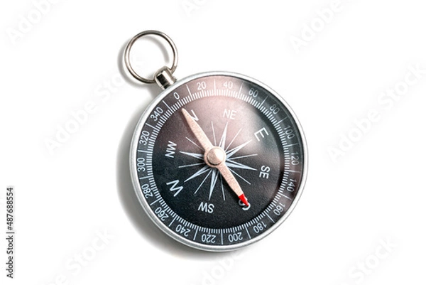 Fototapeta Compass with a black dial isolate on a white background. Traditional navigation device indicating the cardinal points (north, south, east, and west).