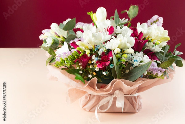 Fototapeta Bouquet of spring flowers on a colored background. Postcard. Place for text. March 8. Valentine's Day.